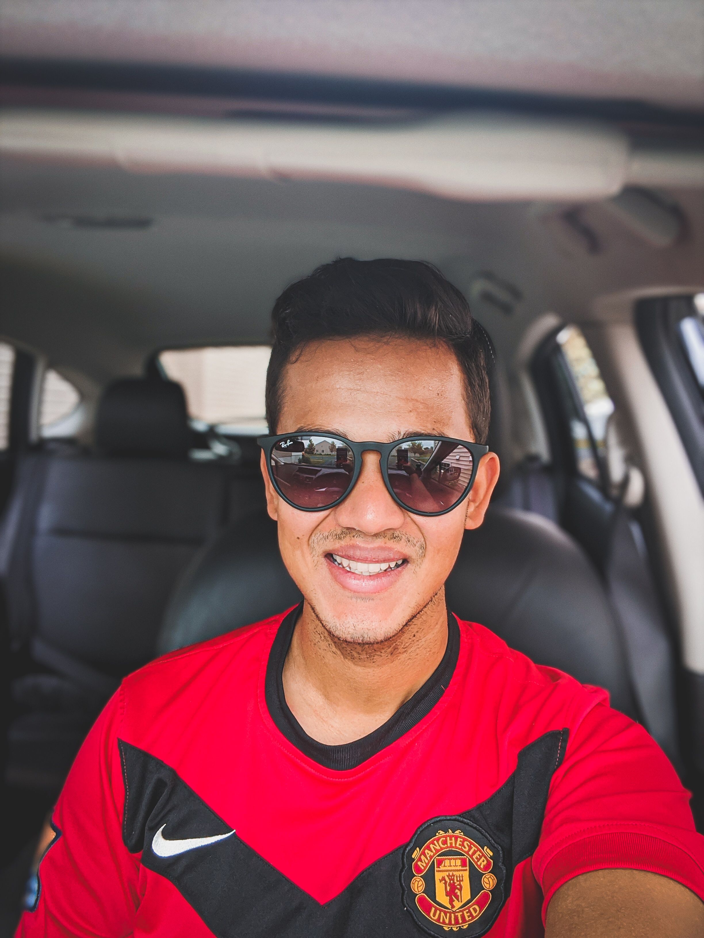 Portrait of Saurav kattel wearing the greatest Soccer team of all time, Manchester United. 